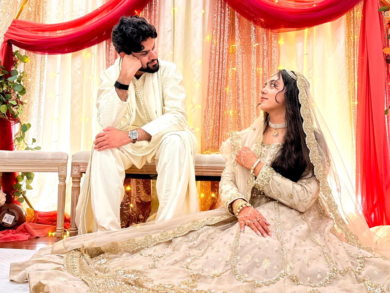 Maham and Shahwaiz looking at each other at their celebration